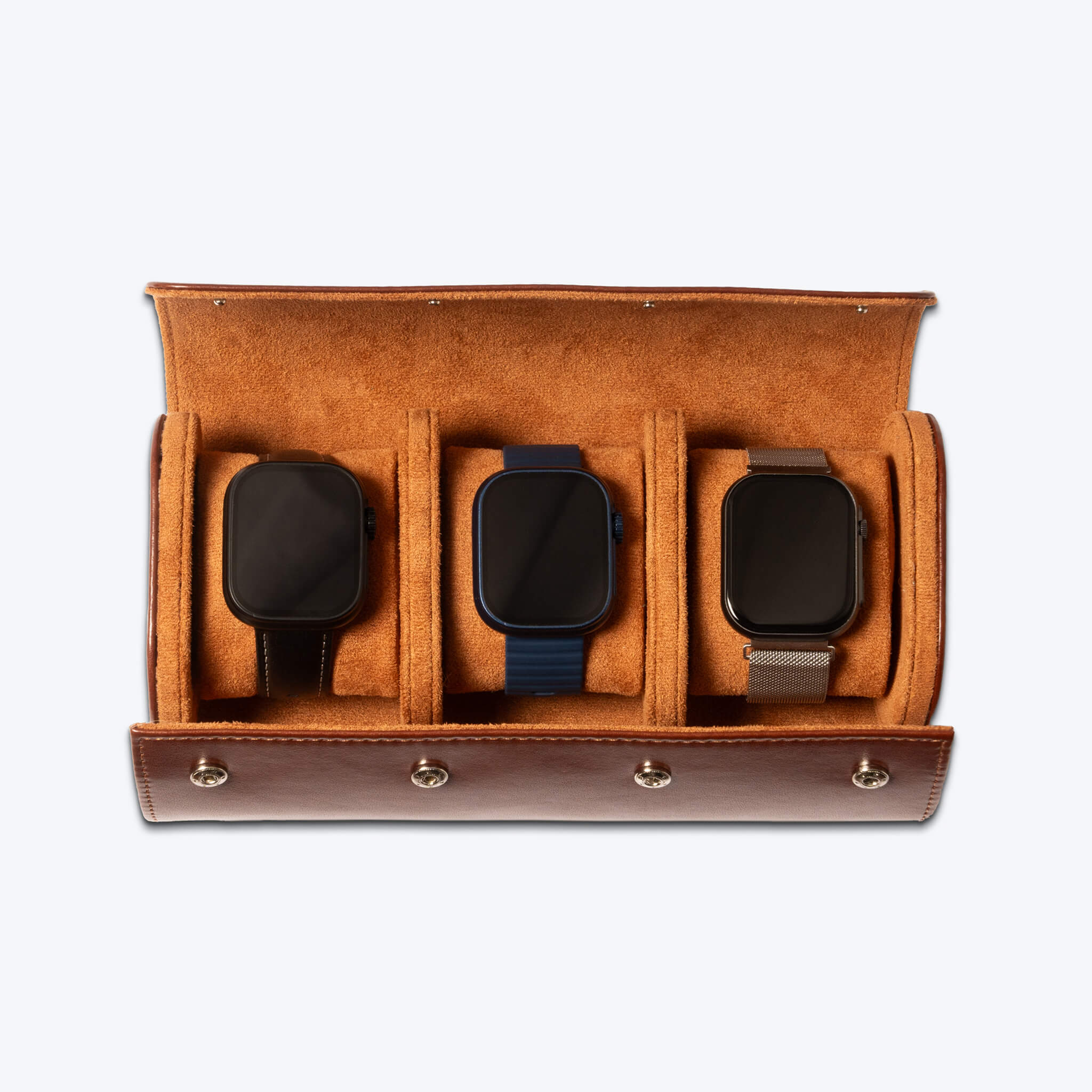 brown leather watch roll with three smartwatches inside of it.