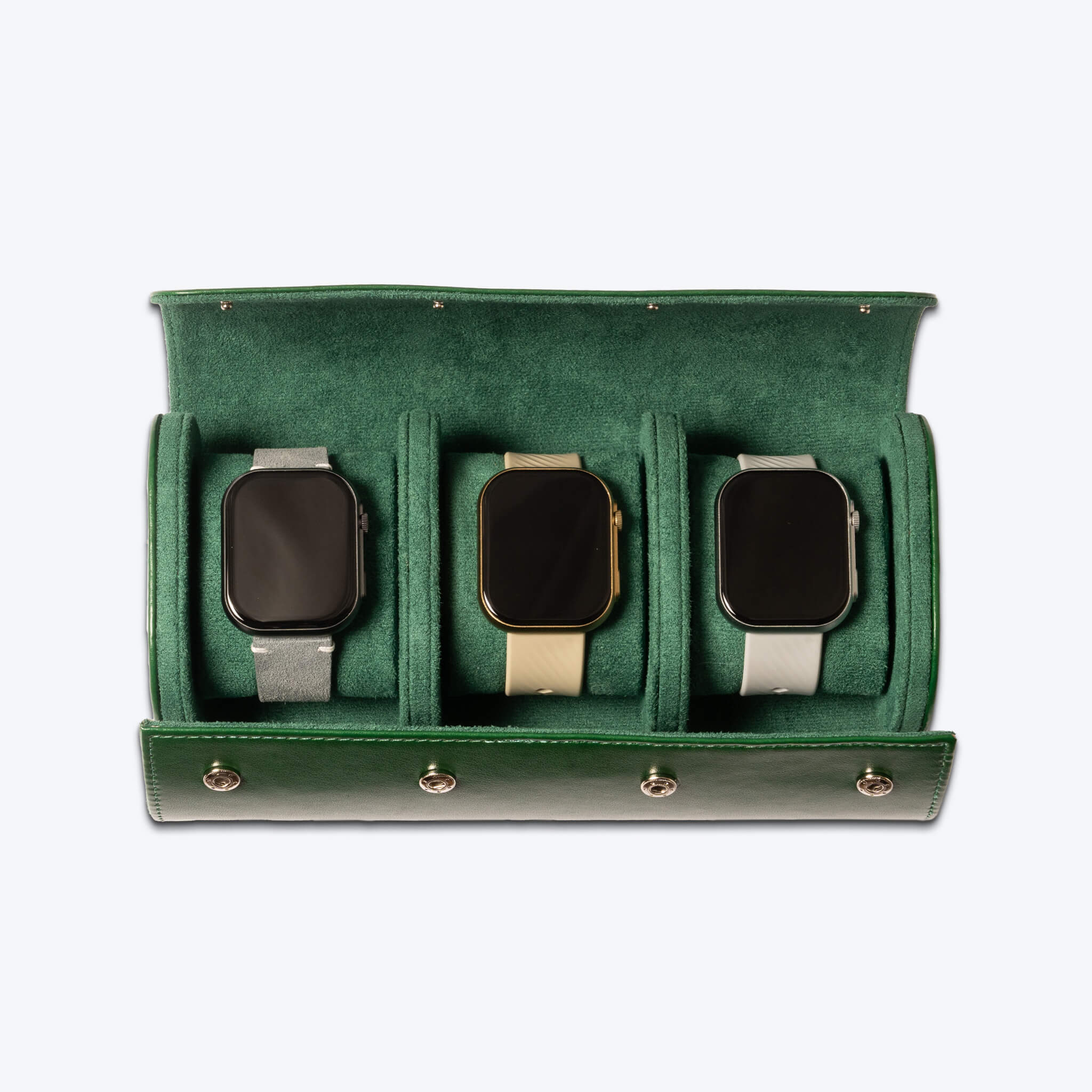 Green leather watch roll with three smartwatches inside of it.