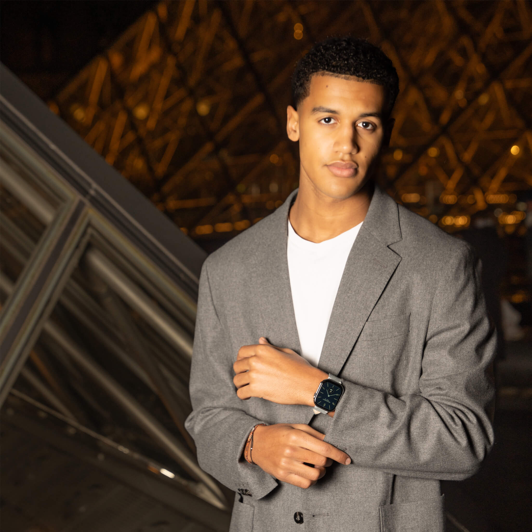 louis model wearing prime smartwatch in grey suede band in Paris.