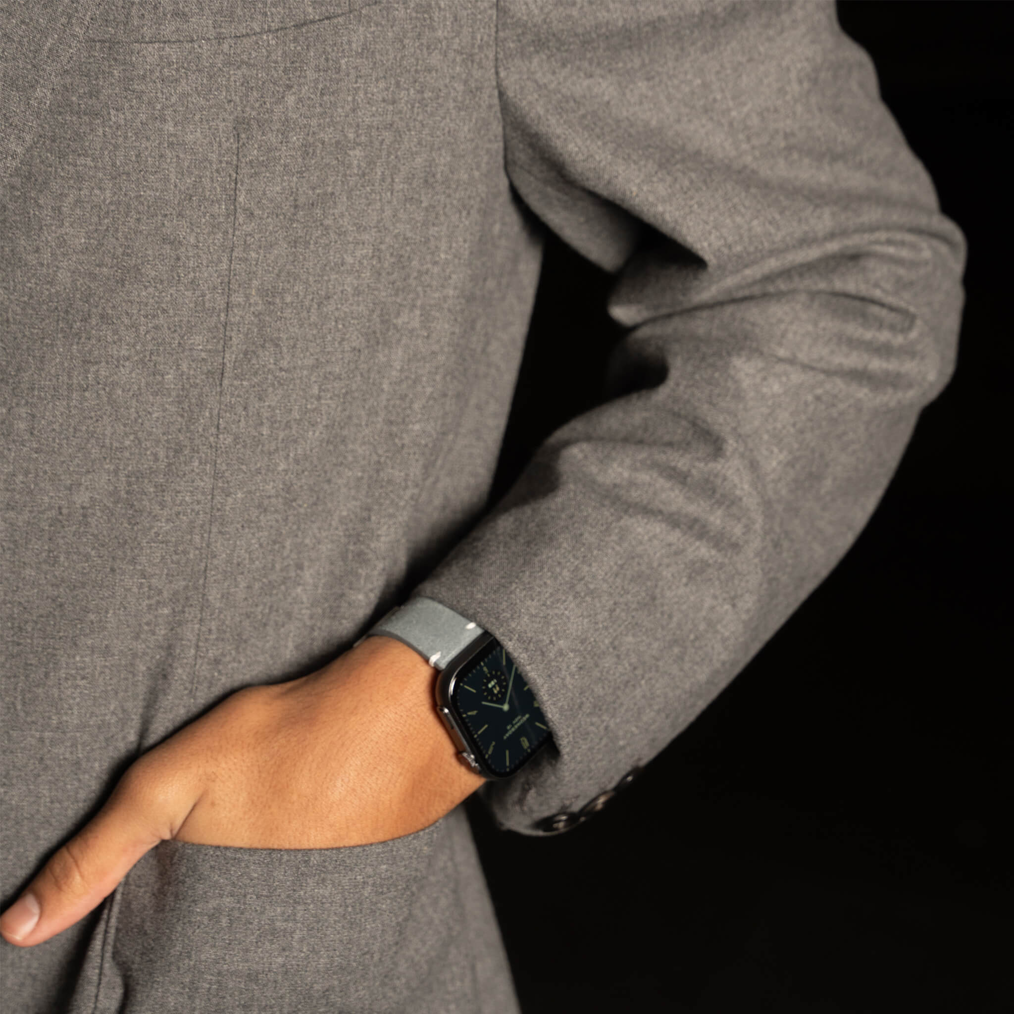 Closeup view of louis model wearing prime smartwatch in grey suede band in Paris.