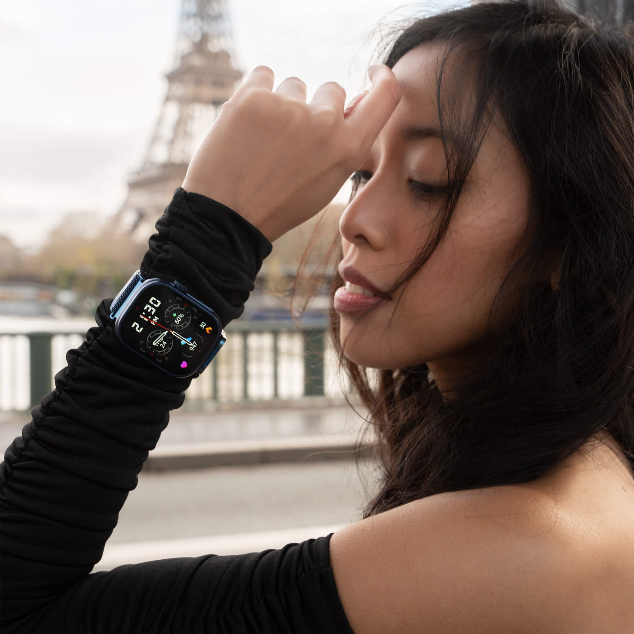 Melanie wearing blue lynx smartwatch near eiffel tower.