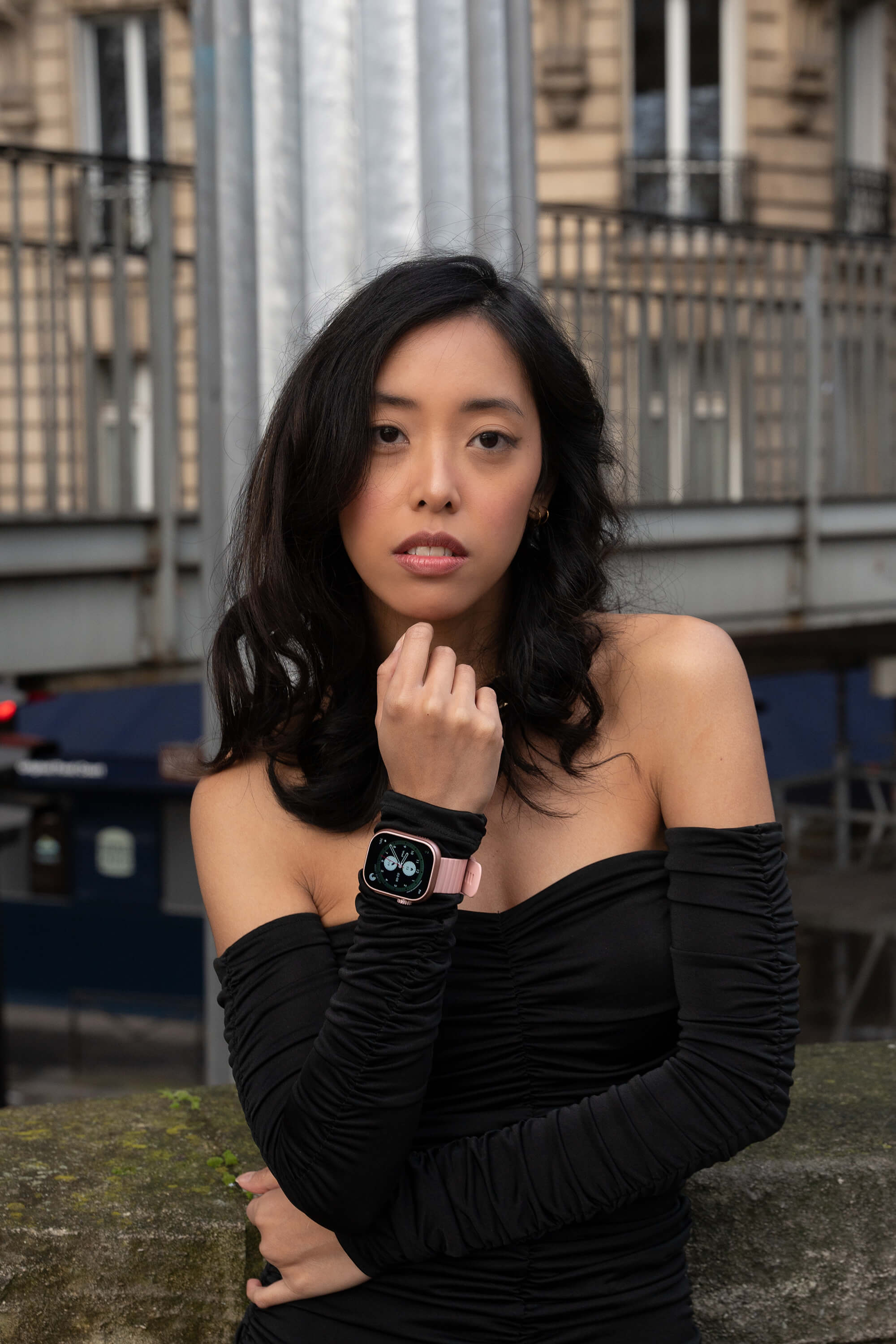 Model Melanie wearing pink lynx smartwatch in the streets of Paris.