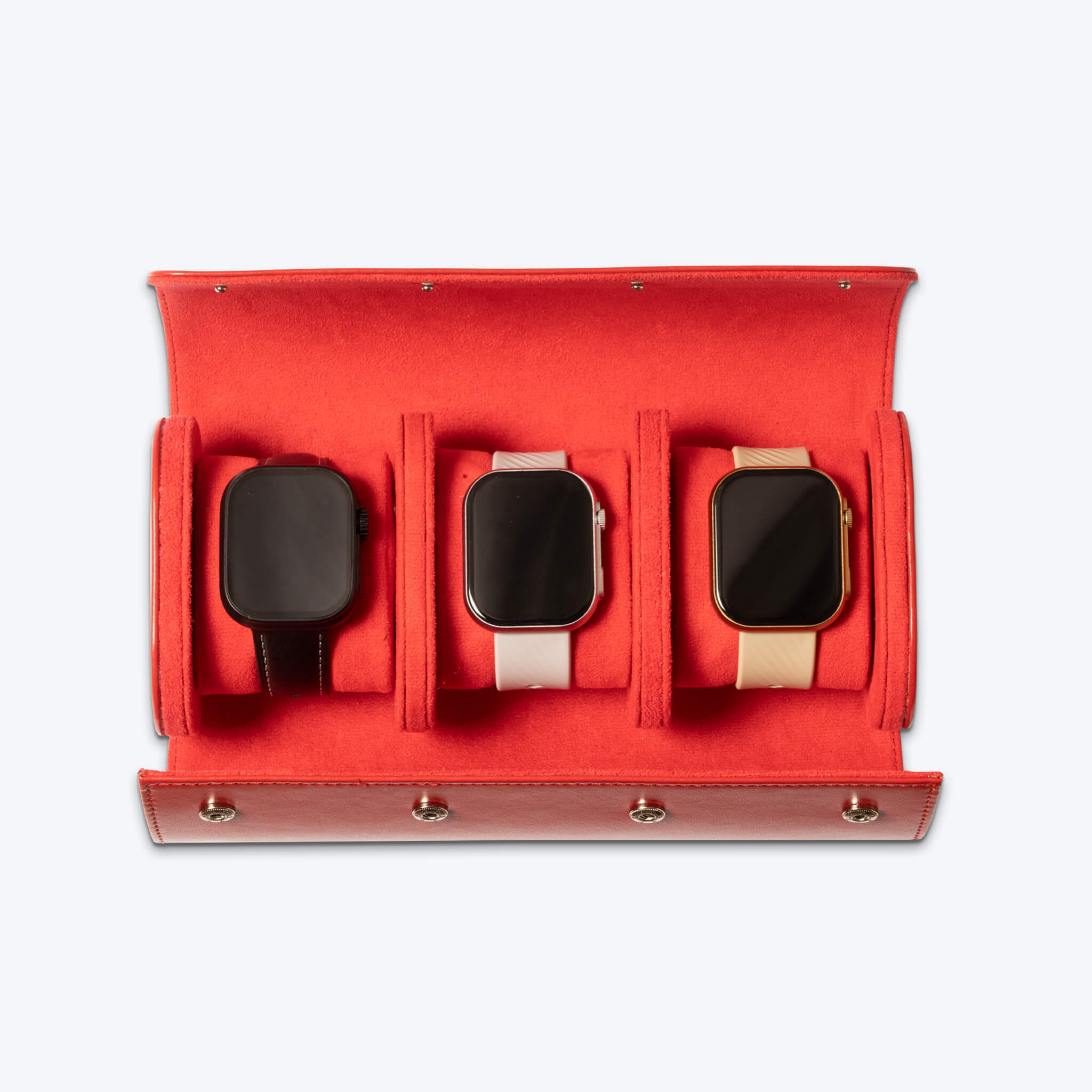 opened red watch roll with smartwatches inside the three slots inside of it.