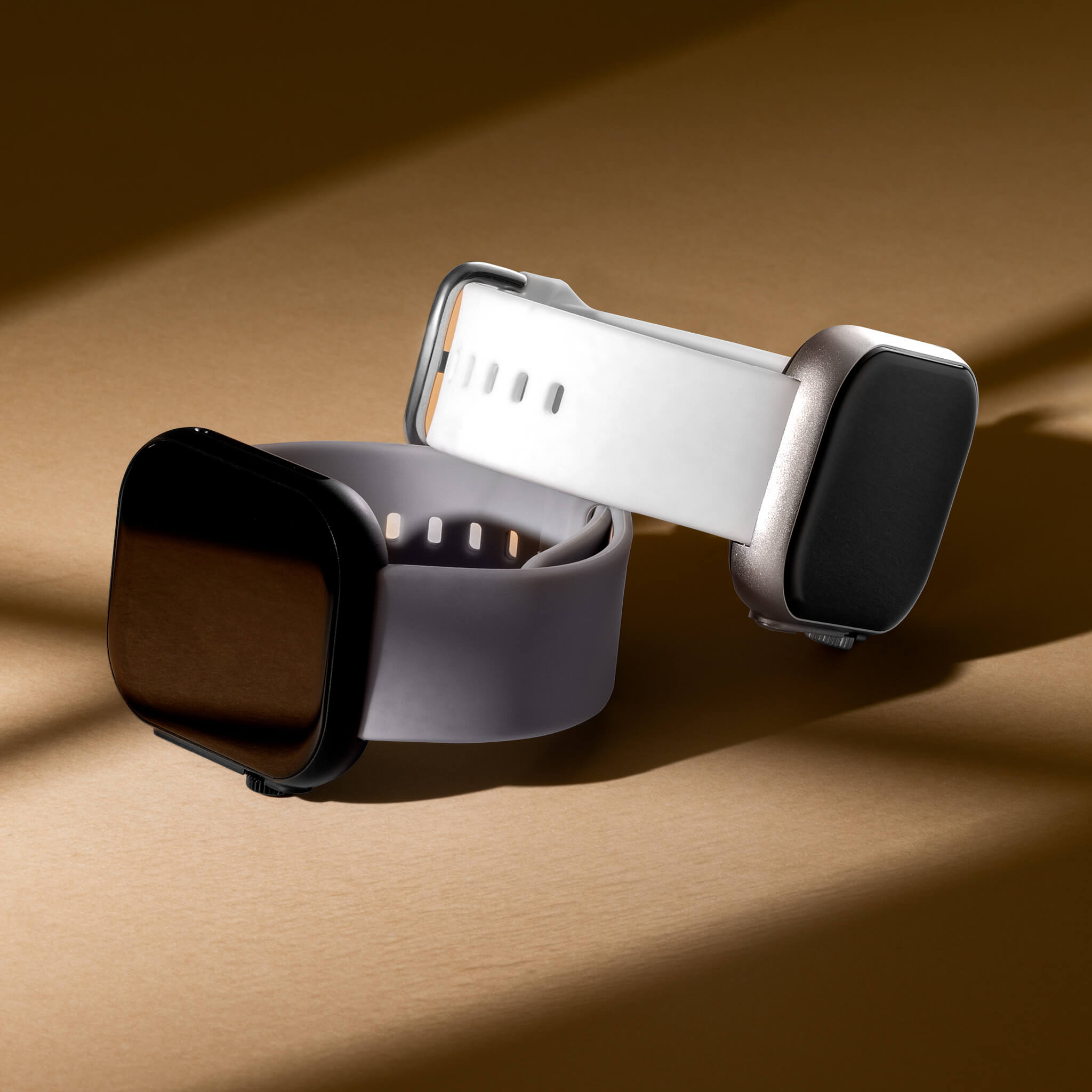 Two Prime Smartwatches with white and grey sport bands in a custom light brown background.